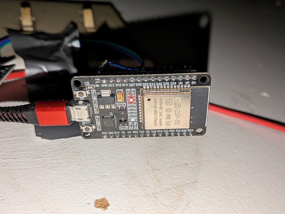 Close-up of an ESP32 DevKit V1 board with a USB cable connected